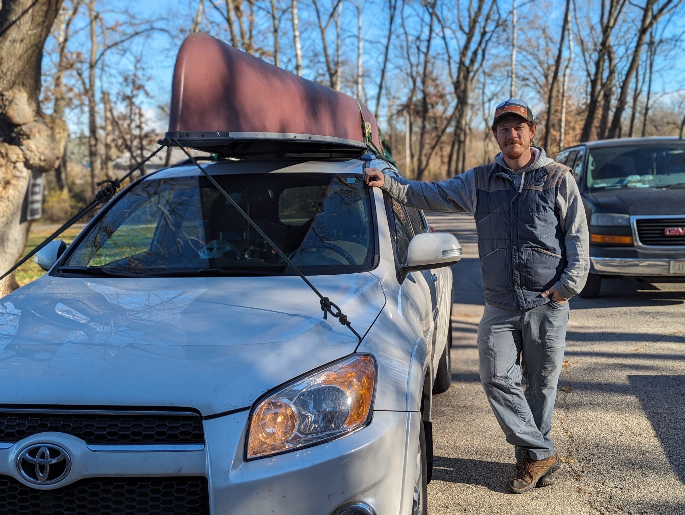 John beside a car with a canoe on the roof