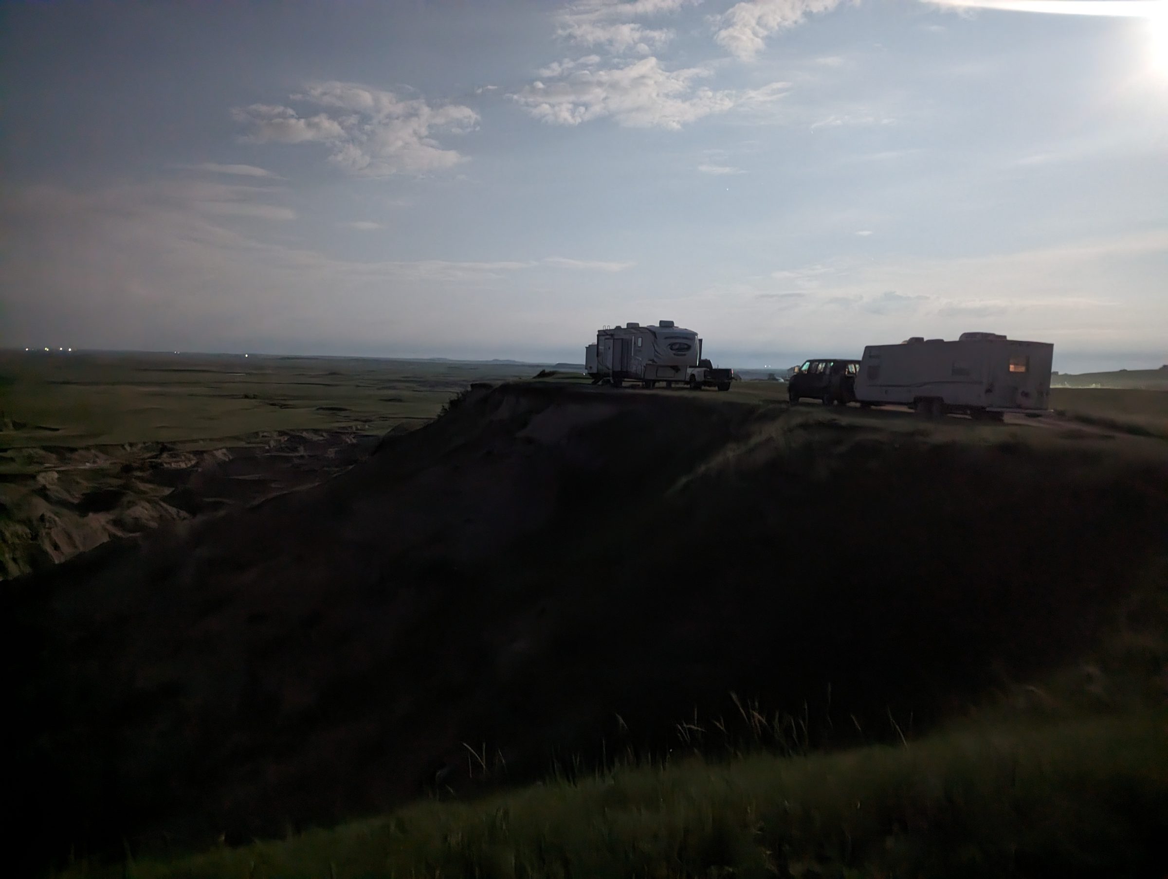 Camper parked at the edge of the Badlands at dusk