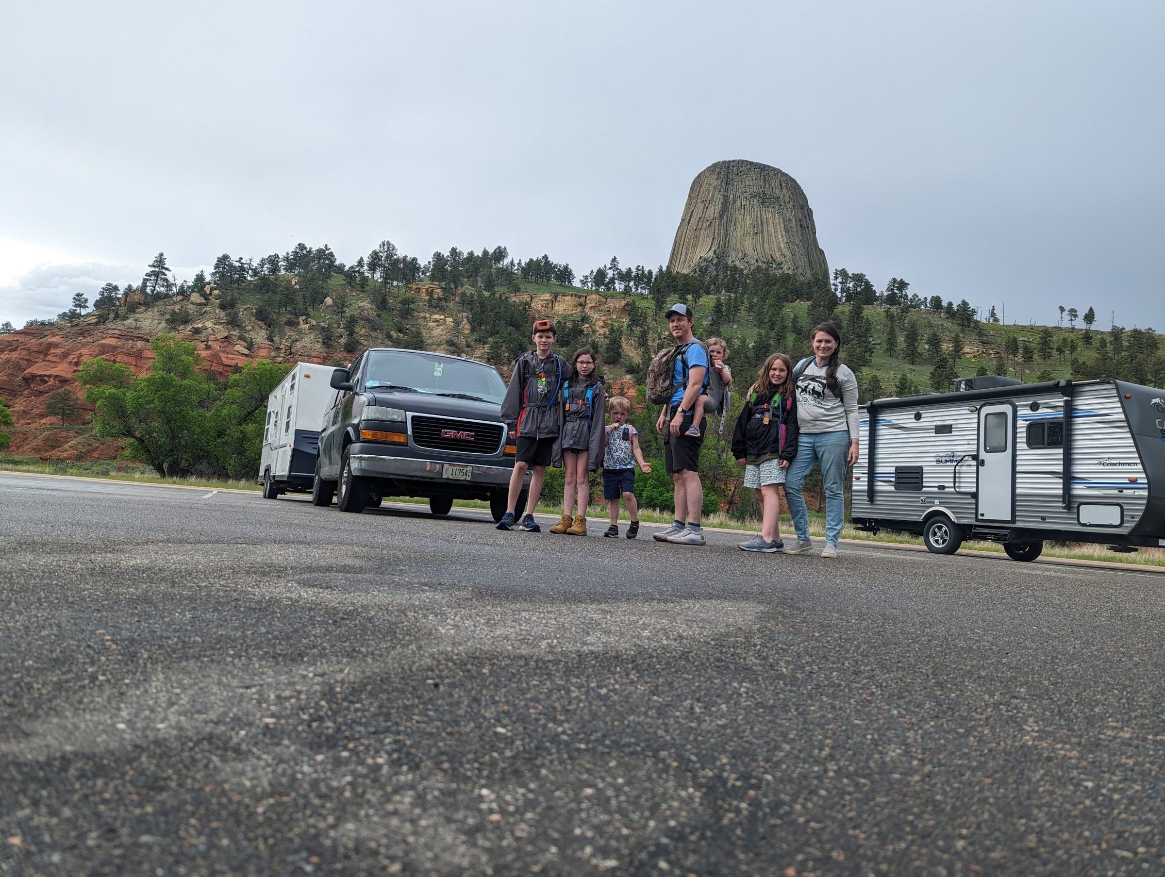 Family and camper in front of Devils Tower
